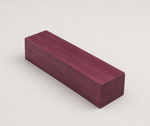 Angled view of a short Purpleheart wood block highlighting its dense grain and vivid purple color for cue building